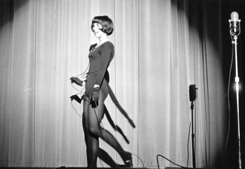 Student singing on stage at Bentley talent show