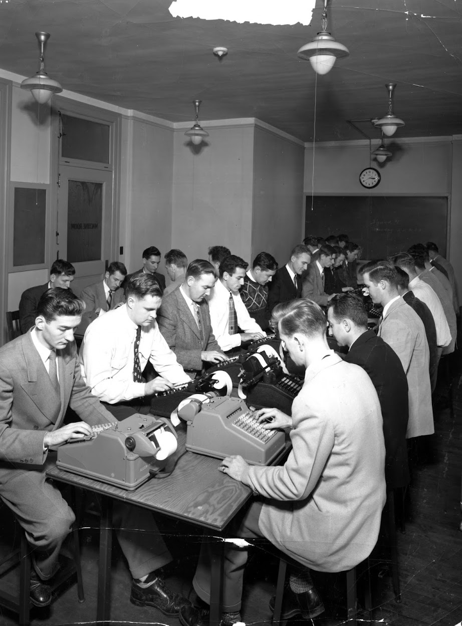 Bentley students working with adding machines in 1948