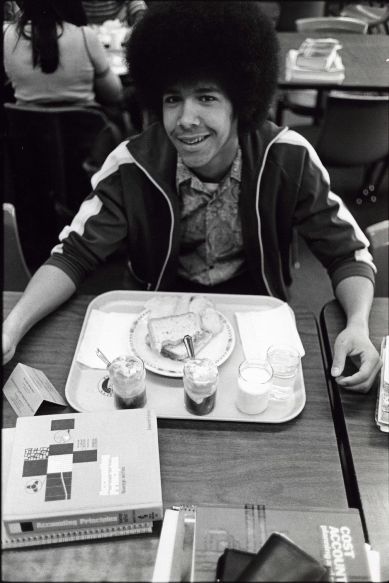 A student eating at the cafeteria, ca. 1970s