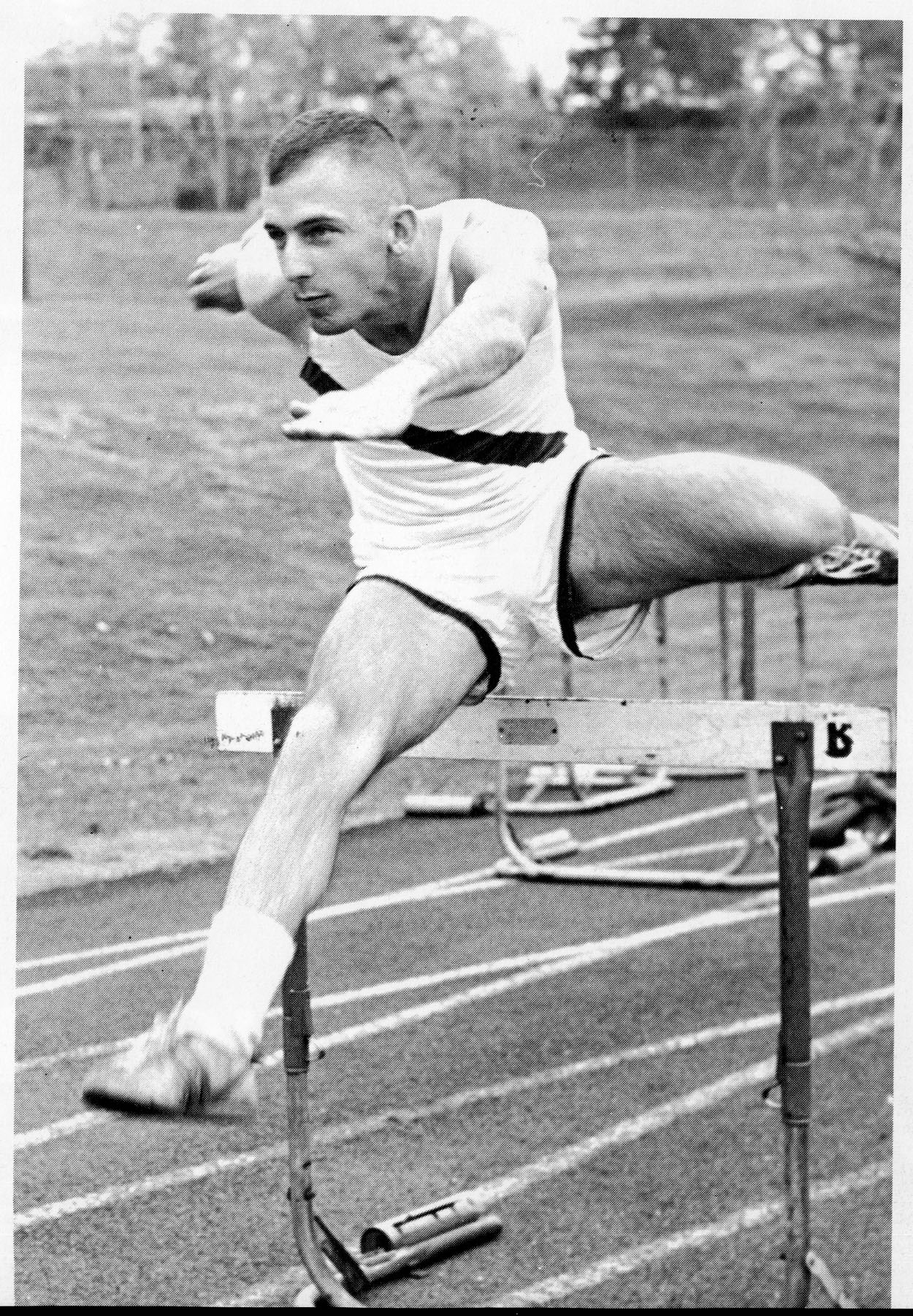 Track Player running hurdles, 1970